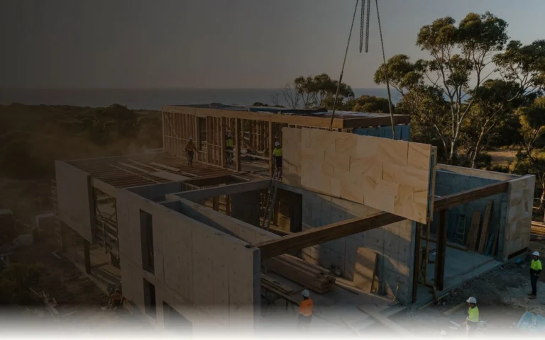 Construction site with building materials being lifted into place, illustrating managed import logistics for builders